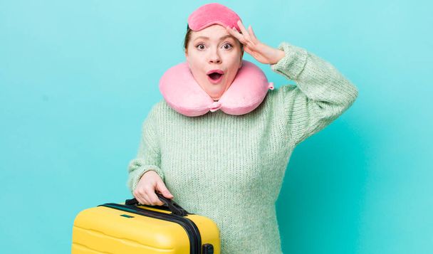 red head pretty woman looking happy, astonished and surprised. flight passenger concept - 写真・画像