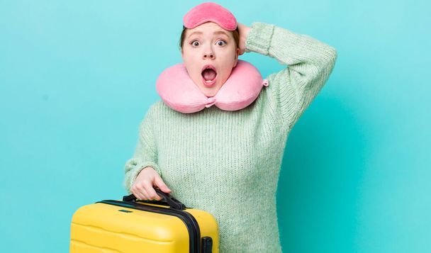 red head pretty woman feeling stressed, anxious or scared, with hands on head. flight passenger concept - 写真・画像