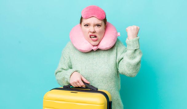 red head pretty woman shouting aggressively with an angry expression. flight passenger concept - Photo, image