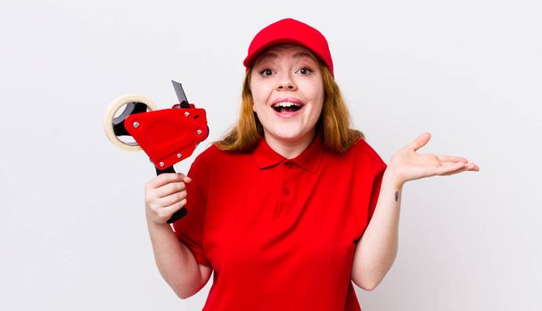 red head pretty woman feeling happy, surprised realizing a solution or idea. packer employee concept - Fotoğraf, Görsel