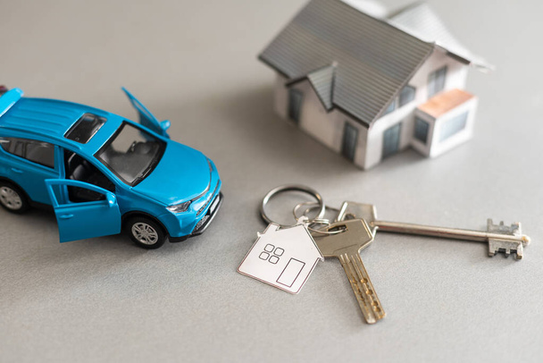 flat lay toy car, toy house, keys and money on the table - Photo, Image