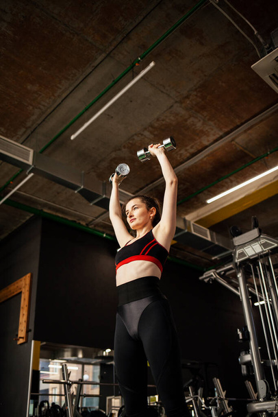 young woman doing exercises in the gym - Photo, image