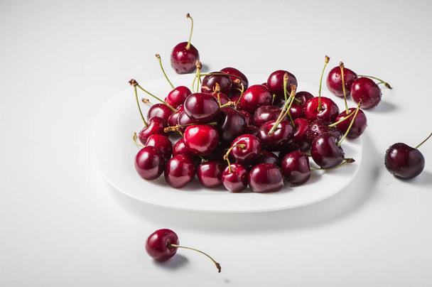 Delicious red berries in dishes on the table. - Photo, image
