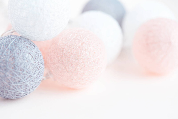 Holiday concept. Illumination from balls with threads. Jewelry and accessories. Birthday. Pastel shades - Foto, Imagem