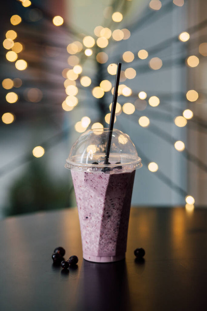 Glass of berry and fruit smoothie on blurred background  - Photo, Image
