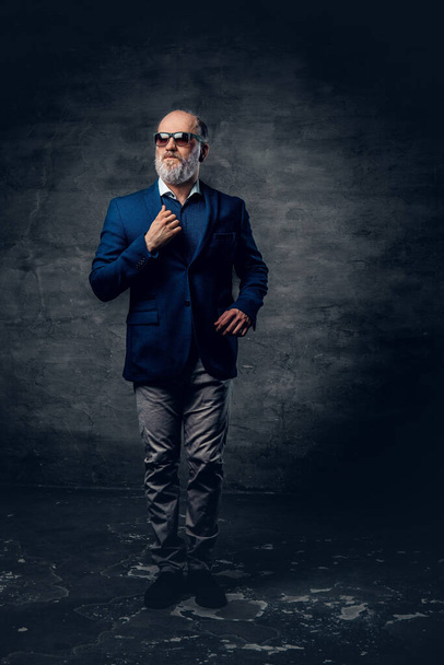 Confident old man dressed in dark blue jacket with sunglasses - Photo, Image