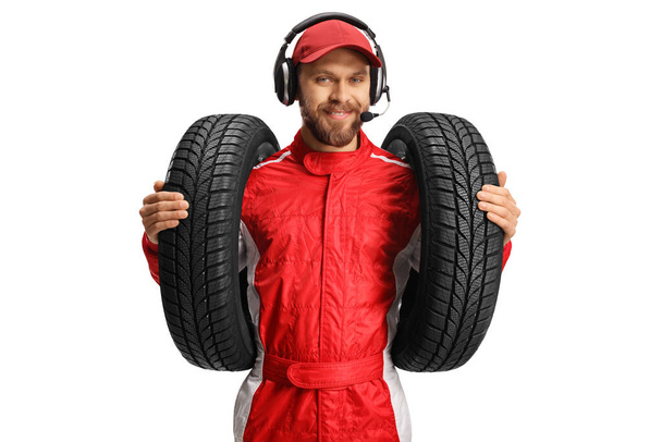 Race team member holding car tires isolated on white background - Zdjęcie, obraz