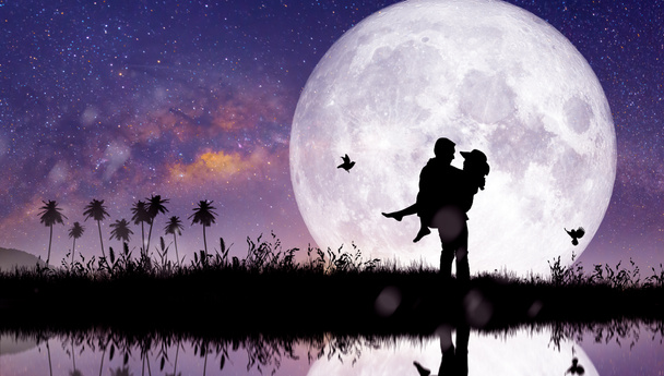 Silhouette at night landscape of couple or lover dancing and singing on the mountain with Milky way background over the full moon. - Photo, Image