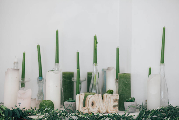 Inscription love, around candles, decorations in the studio - Photo, Image