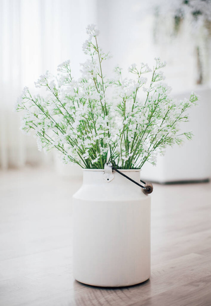 White flowers in a metal vase with handle, vintage, studio decor  - Фото, зображення