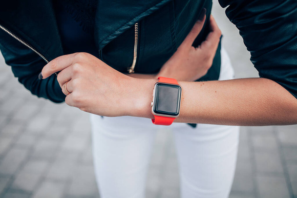 Photo of female hands touching screen generic design smart watch. Film effects, blurred background - Fotoğraf, Görsel