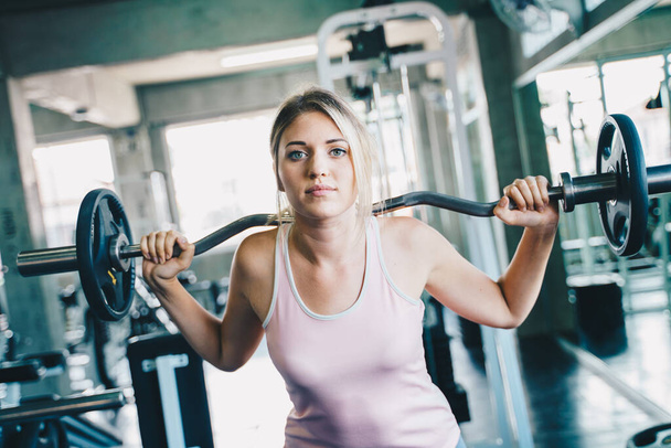 Sport women lift up barbell in fitness gym healthy lifestyle - Foto, Imagem
