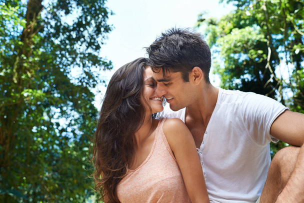 Time for a bit of romance. Shot of an affectionate young couple enjoying a day out in nature. - Photo, Image