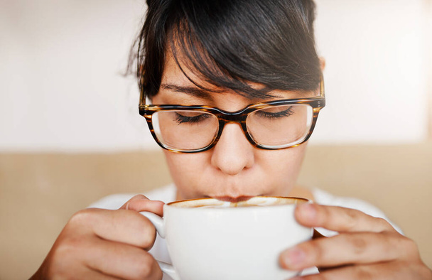 No se puede conseguir cualquier netter. Primer plano de una hermosa joven tomando un sorbo de su café que acaba de comprar dentro de un café durante el día. - Foto, imagen