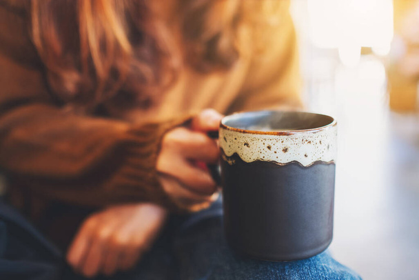 Closeup image of a woman holding a cup of hot coffee  - Φωτογραφία, εικόνα