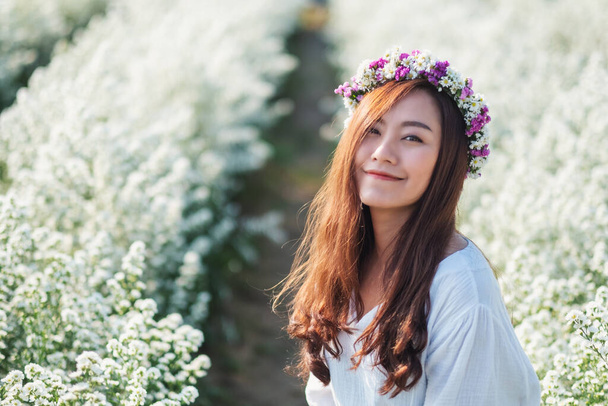 Portrait image of an asian woman in a beautiful Cutter flower field - Photo, Image