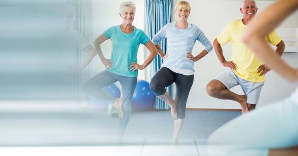 Blur effect with copy space against group of senior people performing yoga at yoga studio. yoga, meditation and retirement home concept - Foto, Bild
