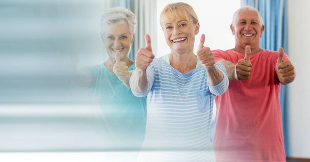 Blur effect with copy space against portrait of group of senior people showing thumbs up. yoga, meditation and retirement home concept - Foto, Bild