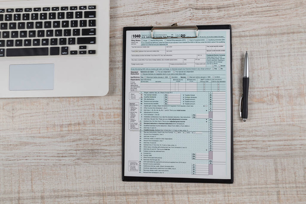 Pohled shora na daňový formulář 1040 s notebookem na stole - Fotografie, Obrázek
