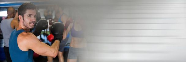 Blur effect with copy space against portrait of caucasian male boxer at the gym. sports and fitness concept - Foto, Imagen