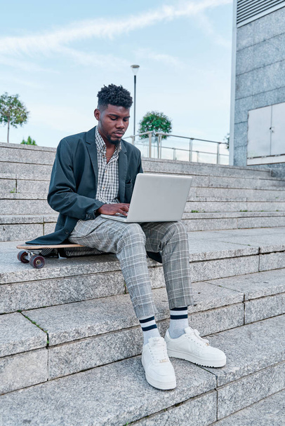 Portrait of african american handsome man in casual wear sitting using laptop for online meeting, video call, video conference. Communication online with colleagues. Online education, remote working. - Φωτογραφία, εικόνα