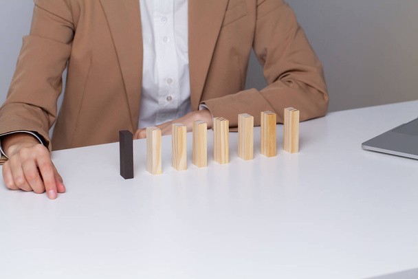 Young business woman in the office makes wooden cubes - Foto, imagen