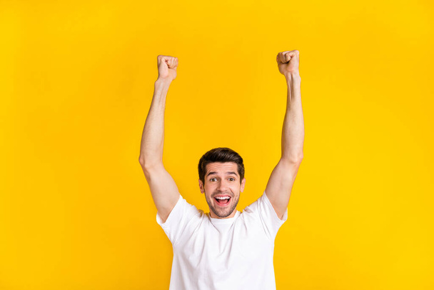 Photo of hooray young brunet guy palms up yell wear trend cloth isolated on yellow color background - Foto, imagen