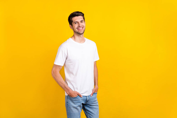 Photo of nice young brunet guy wear casual cloth isolated on yellow color background - 写真・画像