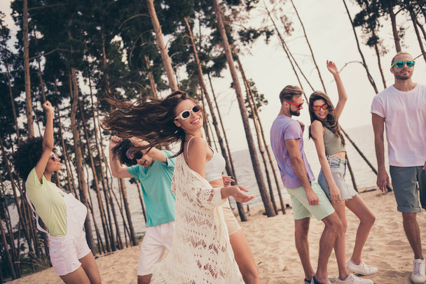 Photo of positive dancer party best friends enjoy beach event wear sunglass casual clothes nature summer seaside beach - Фото, зображення