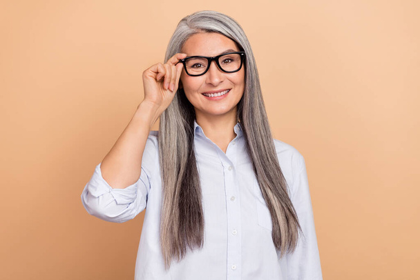 Photo of senior woman eyewear boss intelligent formalwear representative isolated over beige color background - Fotografie, Obrázek