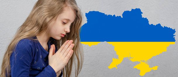Pray for Ukraine. Prayer. The girl is praying. War in Ukraine. - Photo, Image