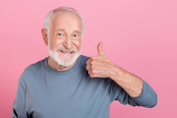 Photo of confident funny retired man grey sweater showing thumb up isolated pink color background - Photo, Image