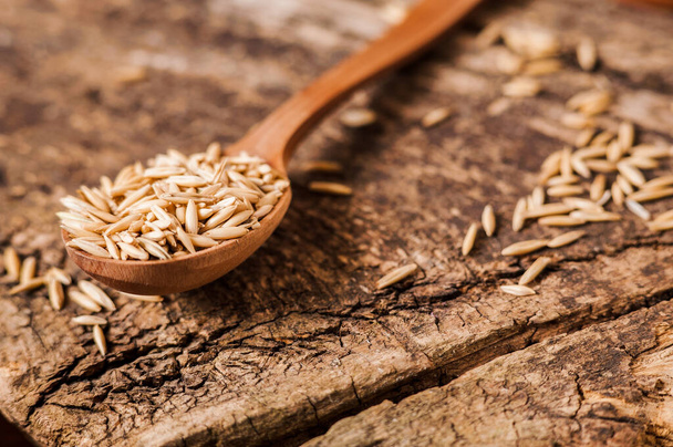 A  Healthy fresh Dry Oat meal .Oat ears of grain on a wooden table, oatmeal. Bounteous harvest.  - Fotografie, Obrázek