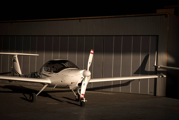 Small private lightweight propeller airplane in hangar. - Фото, изображение