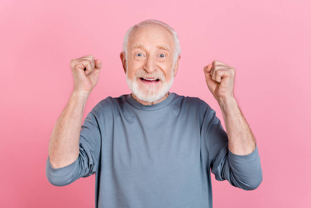 Photo of lucky excited guy pensioner dressed grey pullover smiling rising fists isolated pink color background - Valokuva, kuva