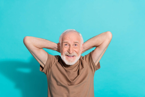 Portrait of attractive cheerful grey-haired man resting looking up copy space isolated over bright blue color background - 写真・画像