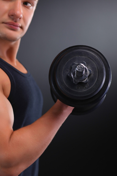 Fit muscular man exercising with dumbbell - Foto, Bild
