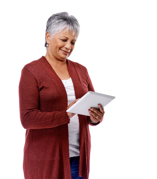 Mature lifestyle. Studio shot of a mature woman using a digital tablet isolated on white. - Foto, immagini