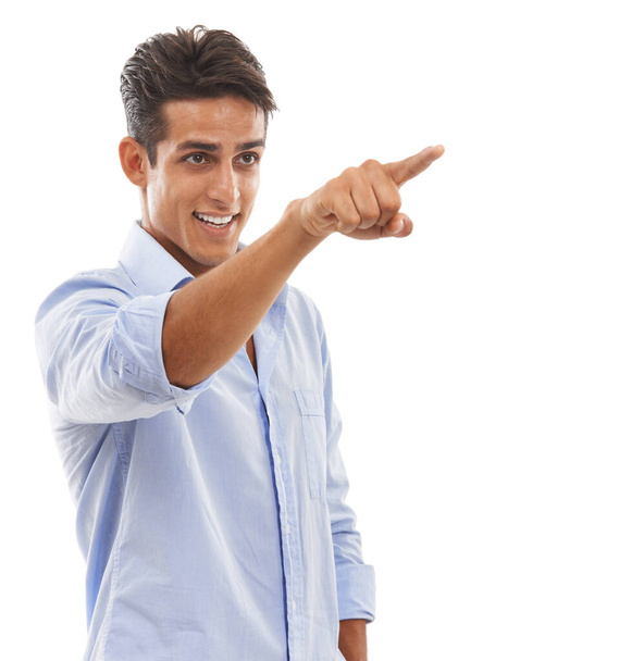 Showing you the way. A handsome young man pointing his finger and smiling against a white background. - Fotoğraf, Görsel