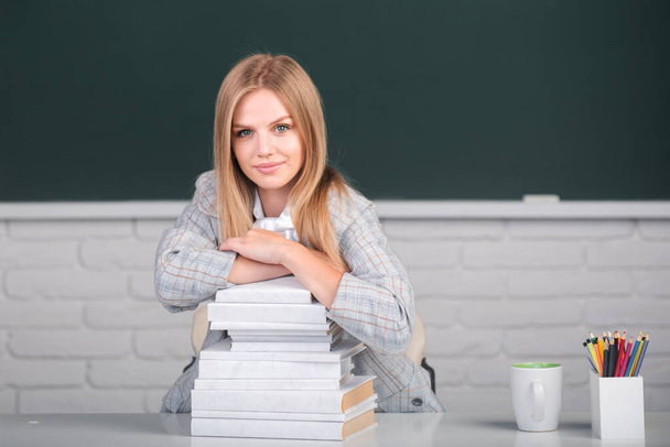 Female student on lesson lecture in classroom at high school or college. Cute student girl with books on blackboard background with copy space. - Fotografie, Obrázek