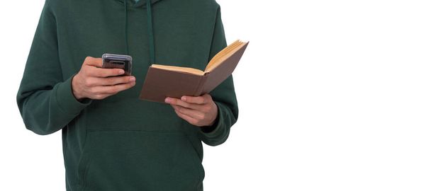 本と携帯電話で隔離された若い男の手 - 写真・画像