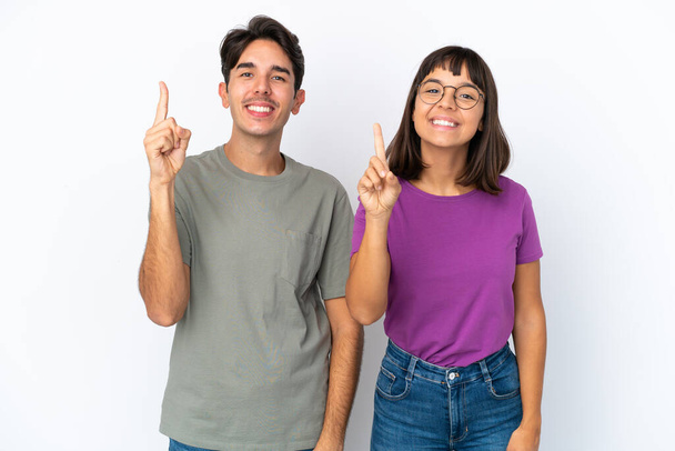 Young couple isolated on isolated white background showing and lifting a finger in sign of the best - Photo, Image