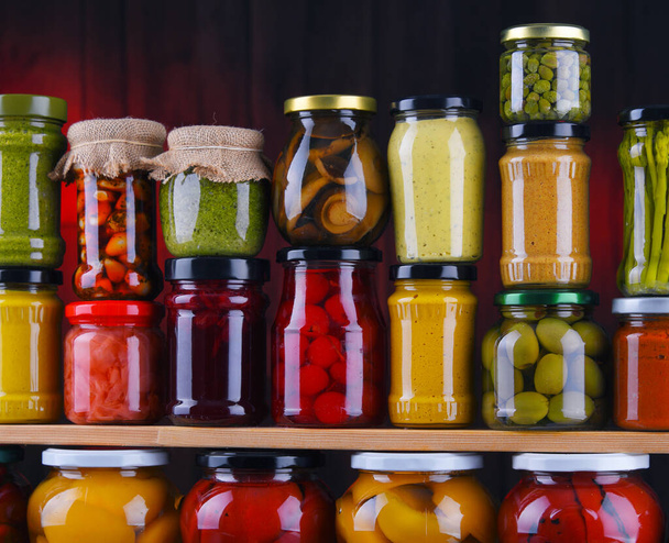 Jars with variety of pickled vegetables and fruits. Preserved food - Fotó, kép