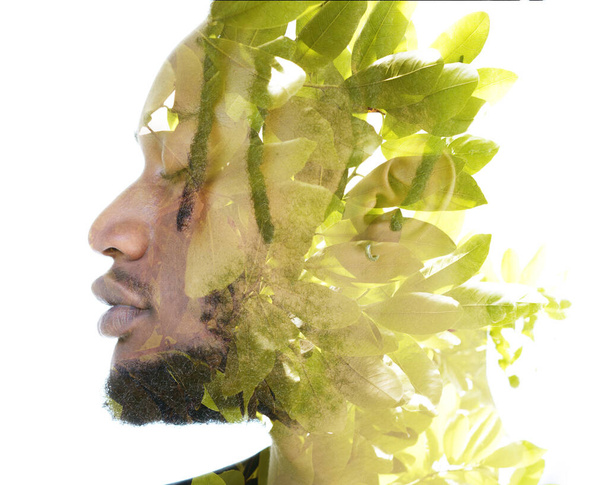 A double exposure portrait of a man combined with an image of green leaves. - Photo, image