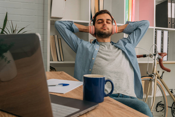 relaxed man listening to music at home with headphones - Photo, Image