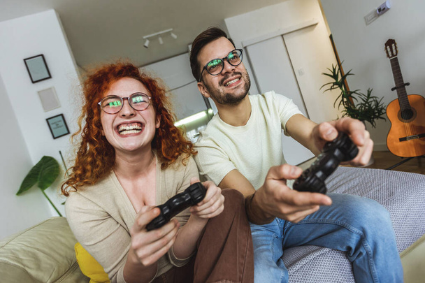  Loving couple are playing video games at home. - Photo, Image