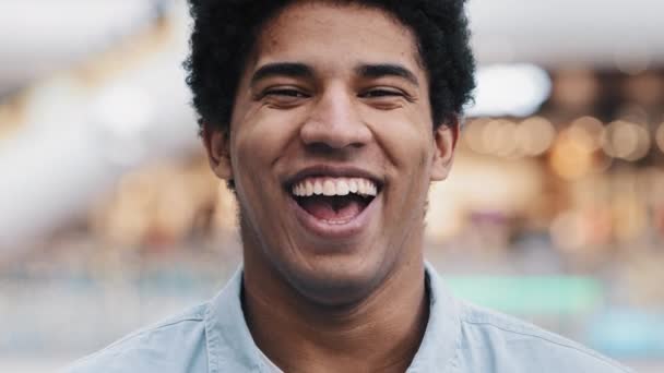 African american 30s man looking at camera having wide sincere toothy smile dental concept laughing guy vlogger recording filming new vlog indoors funny information laugh joy joke head shot portrait - Footage, Video