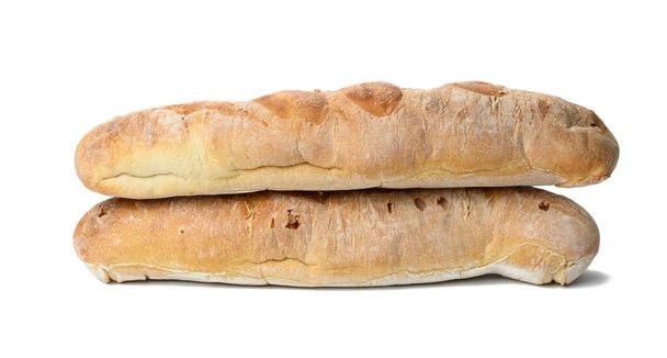 two baked baguettes made from white wheat flour on a white background - Photo, Image