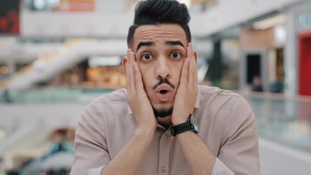 Close up young arabian amazed man surprise receive good offer happy hispanic male won lottery incredible news portrait excited indian millennial guy shocked happiness touching cheeks hold head say wow - Footage, Video