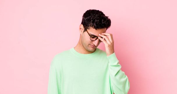 handsome hispanic man feeling stressed, unhappy and frustrated, touching forehead and suffering migraine of severe headache - 写真・画像